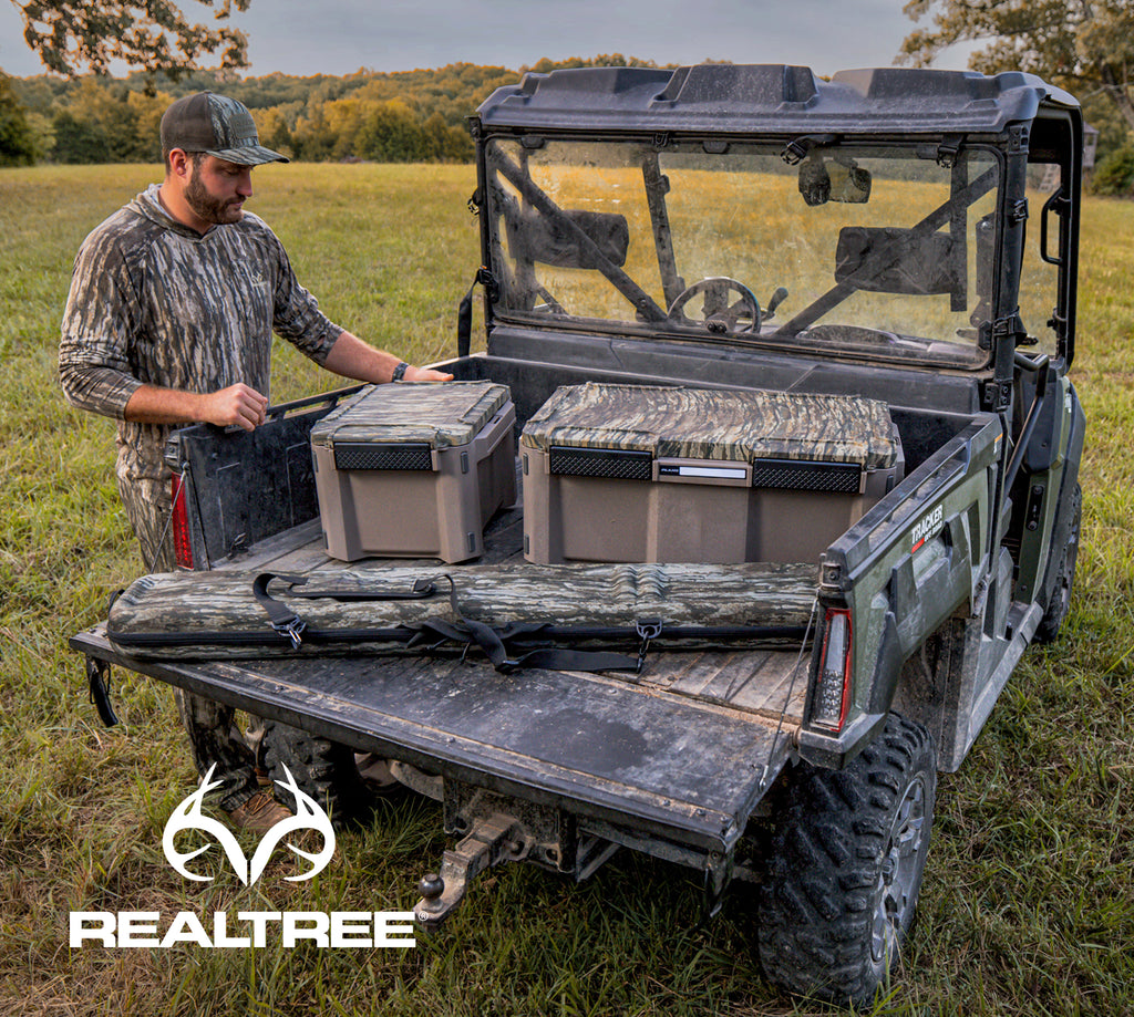 Realtree X Plano product in the field, loaded in the back of an ATV. Mobile. 