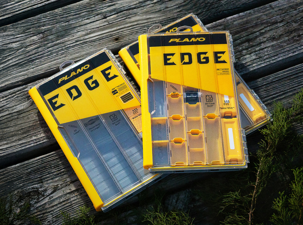 Plano Edge fishing tackle boxes on a wooden surface