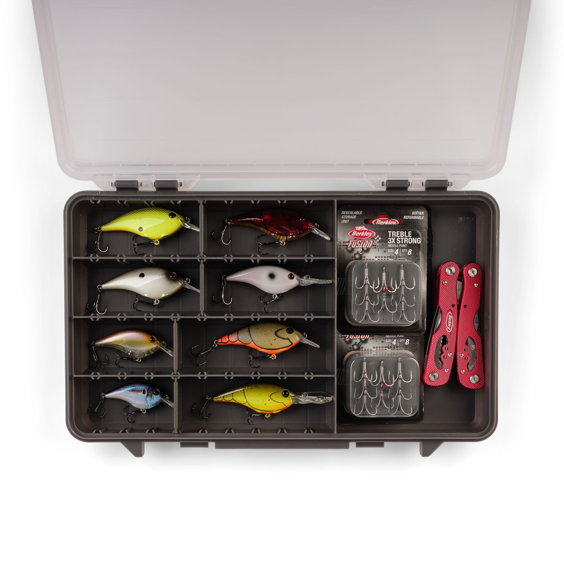 Fishing lure set in a tackle box with tools on a white background