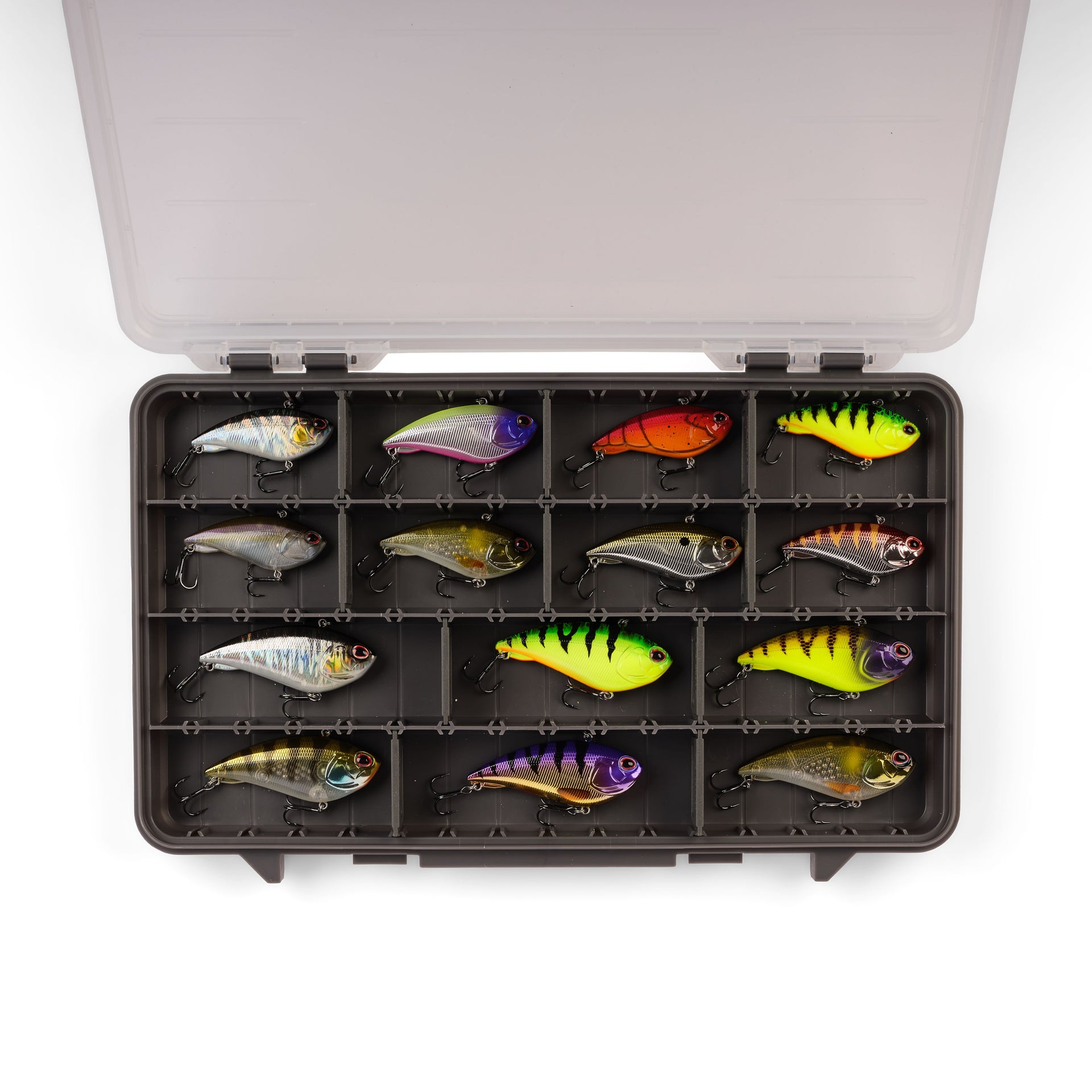 Assorted fishing lures in a tackle box on a white background