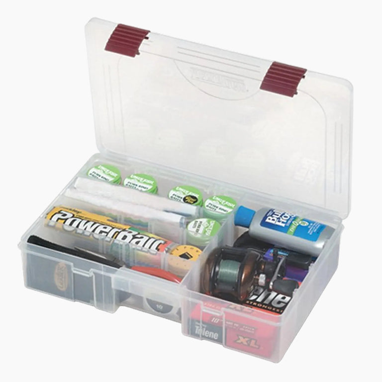 Clear tackle box with various fishing lures and accessories on a white background